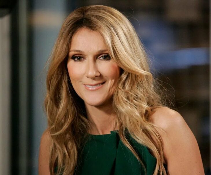 Photograph showing Canadian singer Céline Dion dressed in dark green 