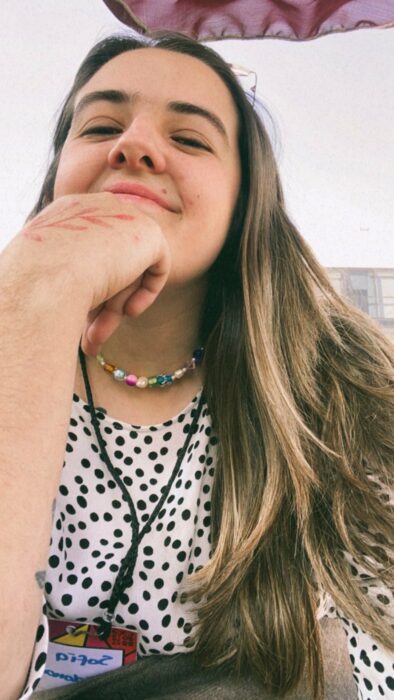 photograph of a girl with her hand on her chin 