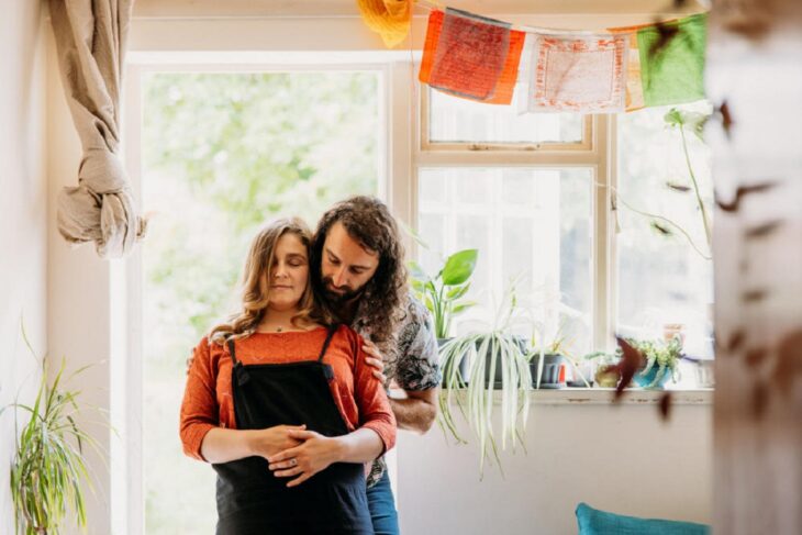 a man practices relaxation techniques with a woman both are standing in a room