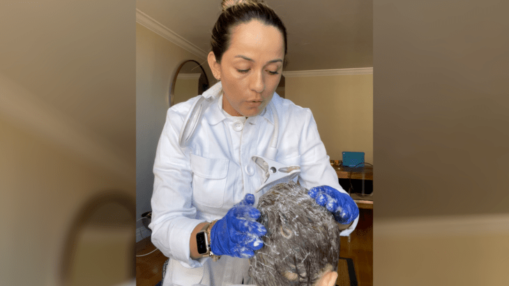 Image showing a woman removing lice from a person 