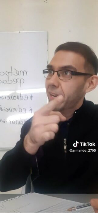 teacher in the classroom explaining to his students 