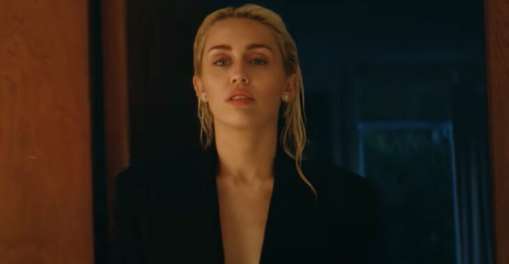 screenshot from Flowers video where Miley Cyrus can be seen dressed in black 