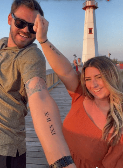 a wedding couple doing funny poses in front of the camera on the pier somewhere behind you can see a lighthouse