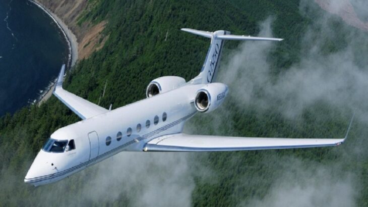 a white G550 jet in flight