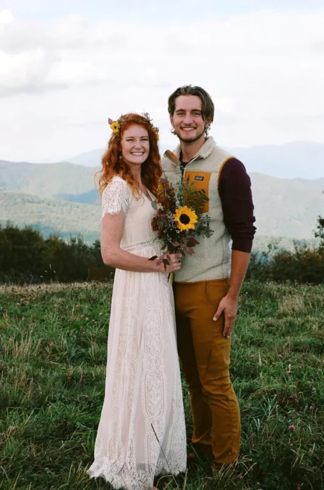 some bride and groom at a wedding in the countryside wear simple and casual clothes