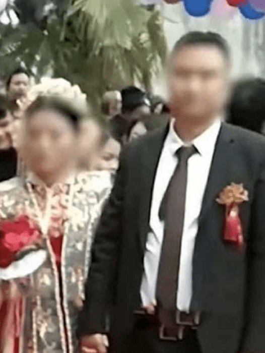 Chinese bride and groom walking down the aisle on their wedding day 