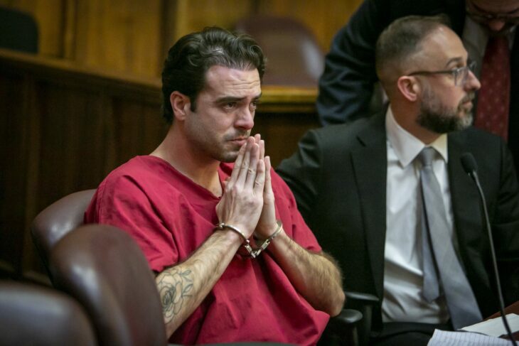 Pablo Lyle with his wrists shackled and his hands crossed over his mouth sitting next to one of his lawyers during his trial