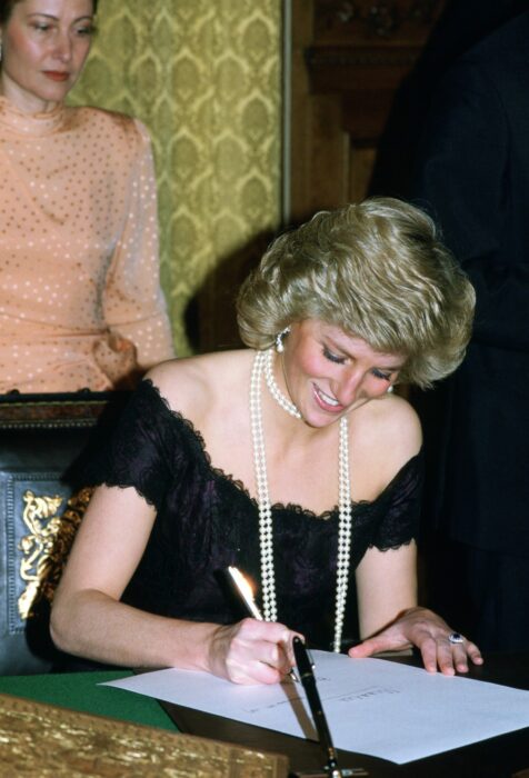 Photograph of Diana Princess of Wales writing on a piece of paper 