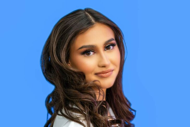 Mya Saldana with a blue background 