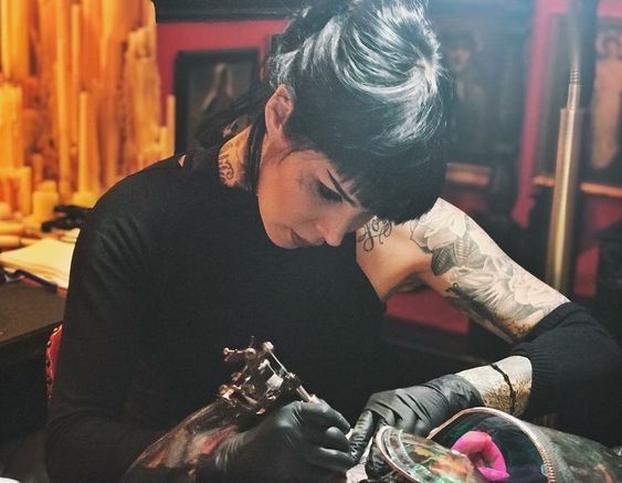 woman tattooing 