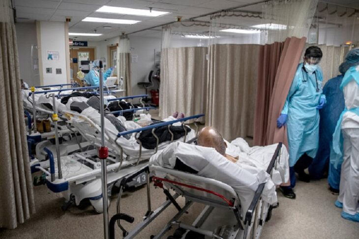 el interior de un hospital de EEUU con varios pacientes acomodados en una misma habitación personal médico los atiende