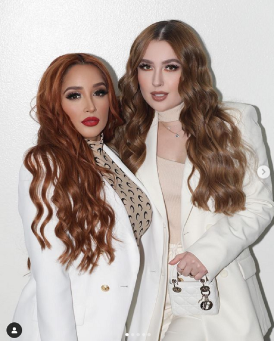 Daisy Anahy, wife of Eduin Caz, together with Kenia Ontiveros, both wear white tailored suits