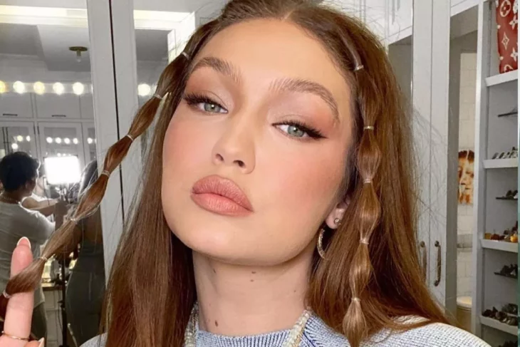 image of the face of the model Gigi Hadid wears her hair in two kinds of braids in front around her face