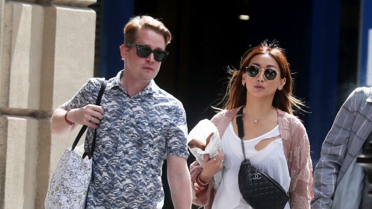 Macaulay Culkin and Brenda Song walking the streets in the United States dressed casually and wearing sunglasses