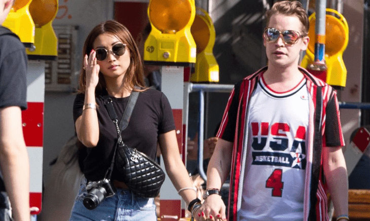 Macaulay Culkin y Brenda Song en un paseo por la calle van tomados de la mano y llevan lentes oscuros