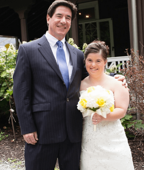 un papá y su hija en el día de la boda de la chica ella está sonriente