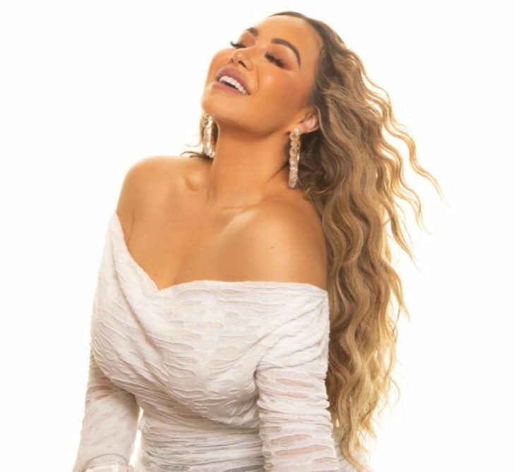 chiquis rivera with white dress and white background 