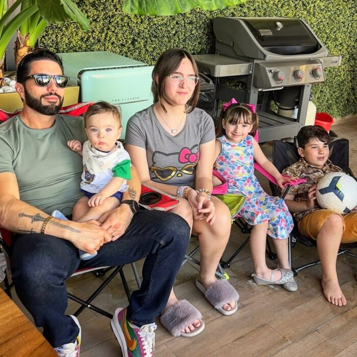 Poncho de Nigris sitting next to his four children 