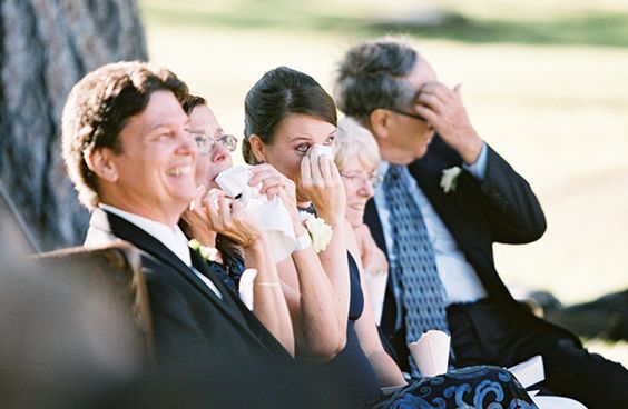 people crying at a wedding