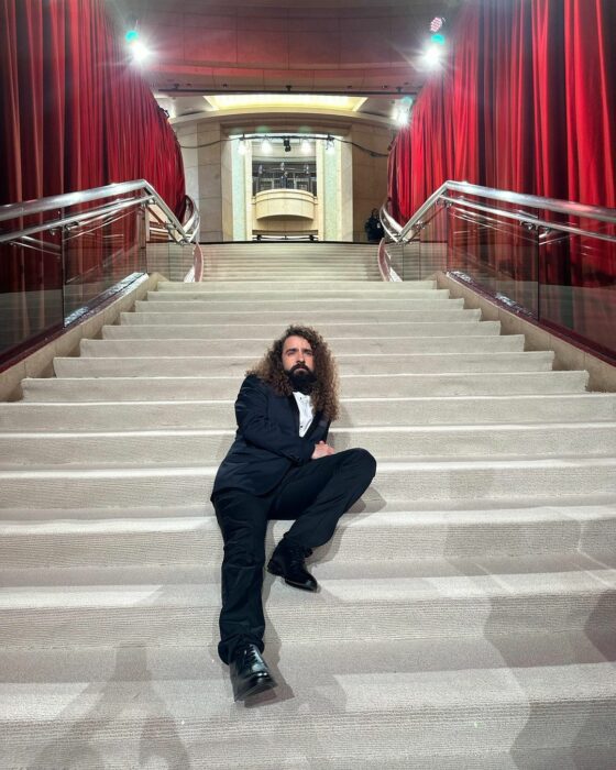 Javier Ibarreche sitting on the stairs of the Oscars gala