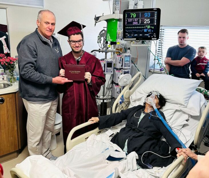 Photograph of a young man receiving his high school certificate in the hospital with his hospitalized mother 