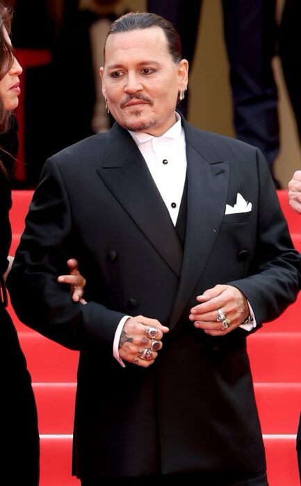 Johnny depp posing on the red carpet at the 2023 cannes film festival