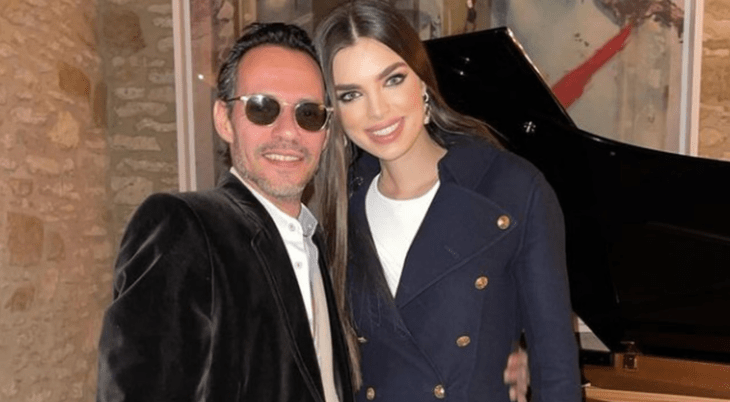 Marc Anthony and Nadia Ferreira pose smiling in semi-formal clothes 