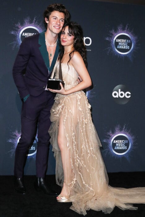 Camila Cabello and Shawn Mendes embrace at an awards ceremony 